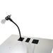 Microphone on a stand attached to a white surface with a black base.