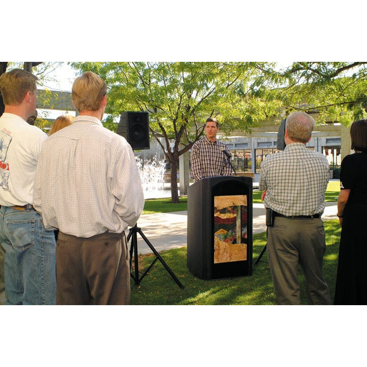 Man speaking behind a podium with a microphone